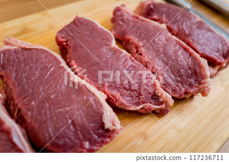 Raw fillet beef meat for steaks on the cutting board Raw fillet beef meat for steaks on the cutting board 117236711