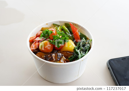 A bowl of food with a variety of vegetables and meat 117237017