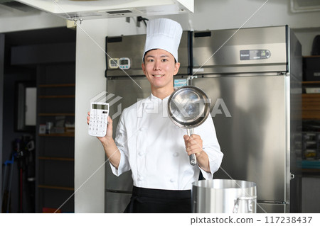 Young asian male cook holding a pot and calculator 117238437