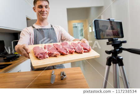 The chef is broadcasting live from workshop how to prepare a beef steaks on the electric grill 117238534