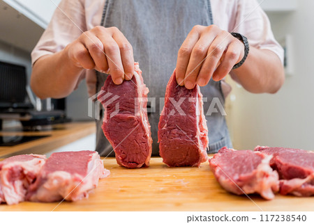 Raw fillet beef meat for steaks on the home electric grill 117238540