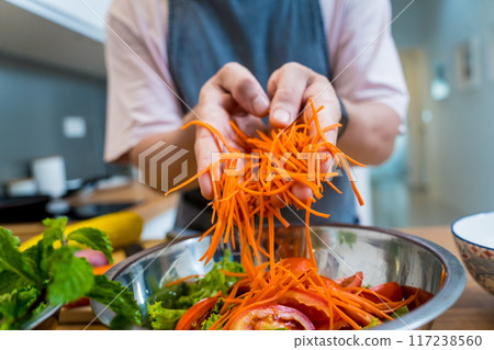 Chef at the kitchen preparing spicy glass noodle salad Chef at the kitchen preparing spicy glass noodle salad 117238560