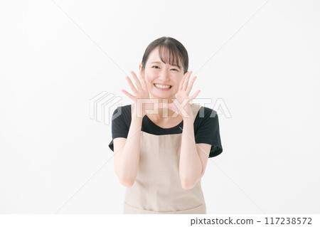 A woman in an apron calling out A woman in an apron calling out 117238572