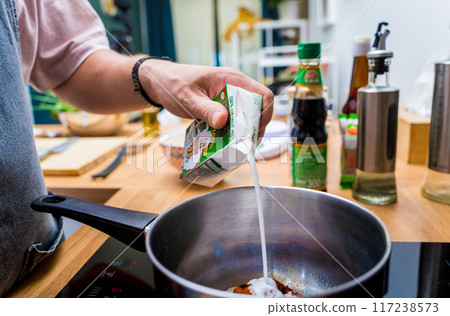 Chef at the kitchen preparing massaman curry with sweet potato and many spices Chef at the kitchen preparing massaman curry with sweet potato and many spices 117238573