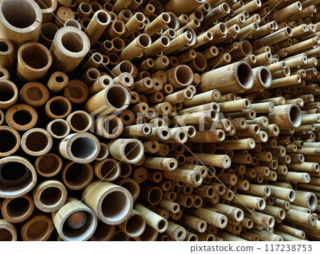 Background of bamboo tubes are arranged in a stack on top of one another Background of bamboo tubes are arranged in a stack on top of one another 117238753