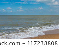 Soft wave beach with golden sand under blue sky  117238808