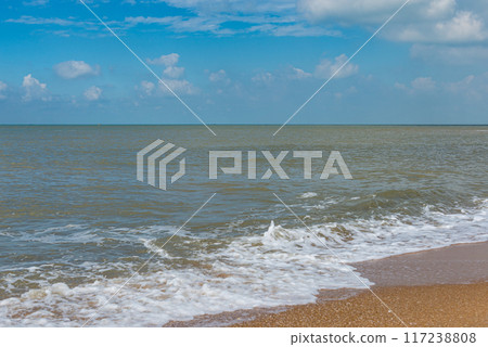 Soft wave beach with golden sand under blue sky  117238808