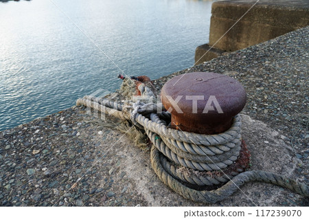 Boat mooring at the port. Mooring a ship with a rope. Anchoring. Mooring. 117239070