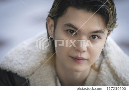 Portrait of a man in his twenties looking at the camera Portrait of a man in his twenties looking at the camera 117239600
