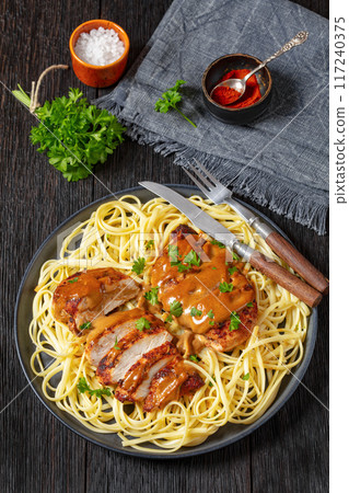 Chicken Lazone with sauce and linguine on plate Chicken Lazone with sauce and linguine on plate 117240375