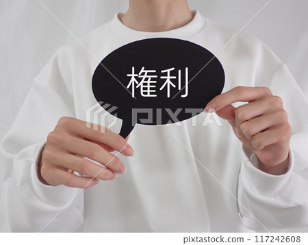A man is holding a speech bubble with the word "rights" written on it 117242608