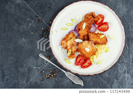 Fried fish in batter. 117243499