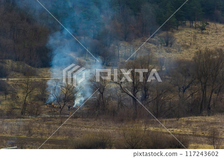 agricultural waste bonfires from dry grass and straw stubble burning with thick smoke polluting air during dry season causing global warming and carcinogen fumes 117243602