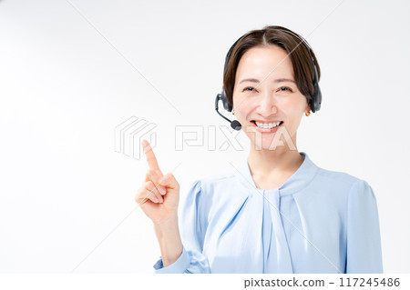 Woman wearing a headset pointing 117245486
