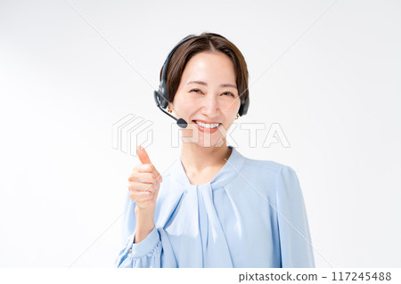 Woman wearing a headset thumbs up 117245488