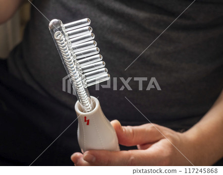 Close up shot of the high frequency comb tool for hair and scalp treatment. 117245868