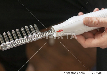 Close up shot of the high frequency comb tool for hair and scalp treatment. 117245870
