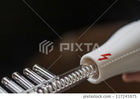Close up shot of the high frequency comb tool for hair and scalp treatment. 117245875