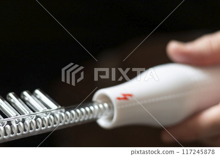 Close up shot of the high frequency comb tool for hair and scalp treatment. 117245878