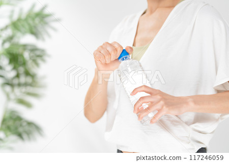 Woman holding a plastic bottle, no face 117246059