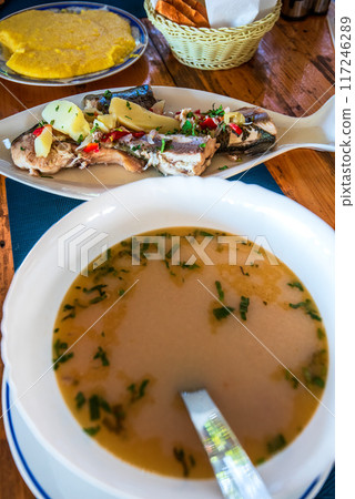 Bors de Peste, or Romanian Fish Soup, is a traditional dish served hot, garnished by a slice of crusty polenta (mamaliga). Bors de Peste, or Romanian Fish Soup, is a traditional dish served hot, garnished by a slice of crusty polenta (mamaliga). 117246289