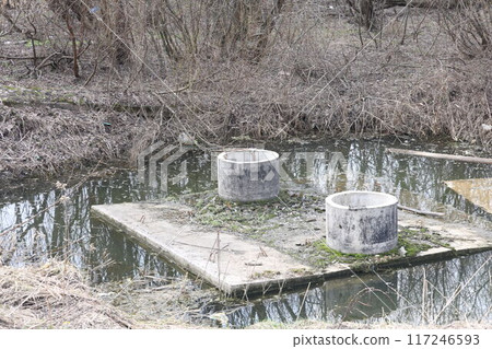 Building structures of a collector under construction flooded with water, spring flood. Building structures of a collector under construction flooded with water, spring flood. 117246593
