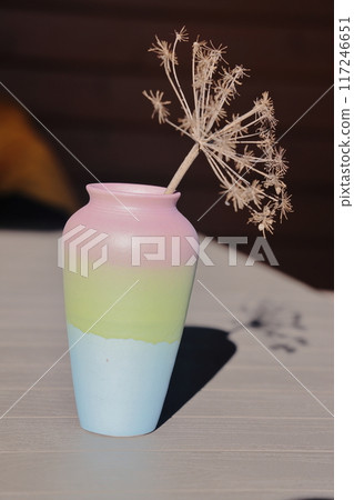 Dried decorative umbellate flowers in a ceramic vase close-up. Floral background. 117246651