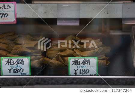 Traditional handmadeKashiwa mochi dispaly in the store. it's a wagashi (Japanese confection) of white mochi surrounding a sweet anko (red bean paste) filling with a kashiwa (oak) leaf  117247204