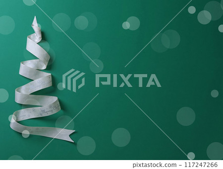 Holidays, celebrations and concept - Christmas tree. White ribbon with words Merry Christmas on green background. Template for design.  117247266