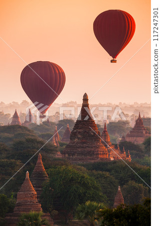 Balloon over plain of Bagan in misty morning, Myanmar 117247301