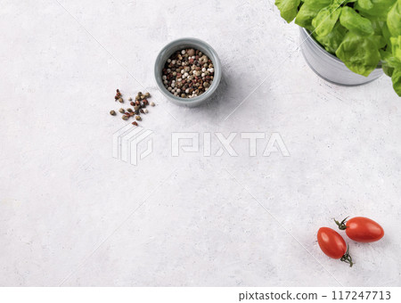 A light background with tomato, spices and fresh basil. The concept of healthy food. 117247713