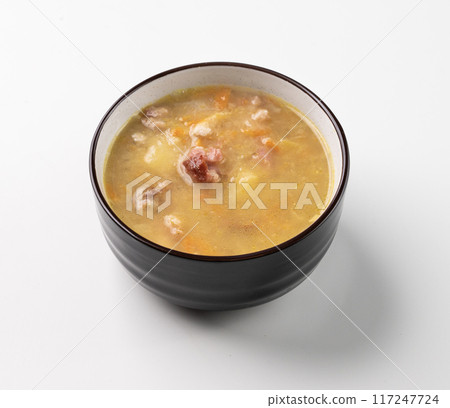 Pea soup with smoked ham in black bowl on white isolated. Healthy homemade  food. 117247724