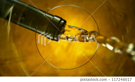 Freeze Motion Shot of White Wine Pouring, Unique Angle of View from the Bottom of the Glass Freeze Motion Shot of White Wine Pouring, Unique Angle of View from the Bottom of the Glass 117248017