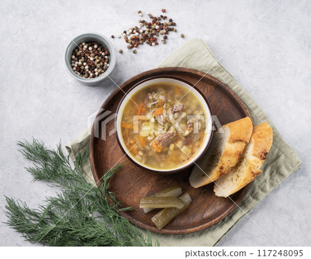 Traditional Russian soup with pickled cucumbers. Pickle with pearl barley and meat  117248095