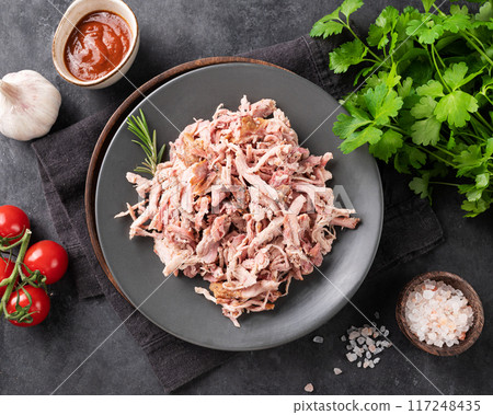 Traditional barbecue torn pork or chicken meat with bbq sauce, fresh tomatoes and herbs Traditional barbecue torn pork or chicken meat with bbq sauce, fresh tomatoes and herbs 117248435