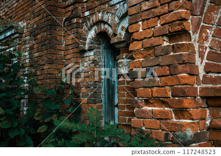 A vertical window in a brick stable. 19th century buildings. 117248523