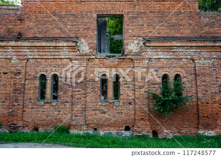 Vertical, narrow windows of a brick stable. 19th century buildings 117248577