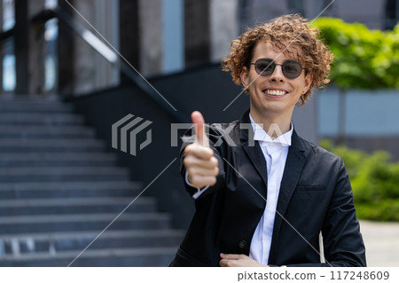 Caucasian business man happy successful satisfied businessman showing thumb up like recommend sign 117248609