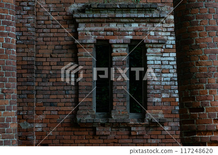 The window of the ruined red brick stable. 19th century buildings. The window of the ruined red brick stable. 19th century buildings. 117248620