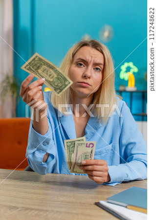 Woman counting cash insufficient amount of money financial crisis bankruptcy poverty destitution Woman counting cash insufficient amount of money financial crisis bankruptcy poverty destitution 117248622