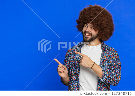 Young man showing pointing at left on blank space place for your advertisement logo Young man showing pointing at left on blank space place for your advertisement logo 117248715