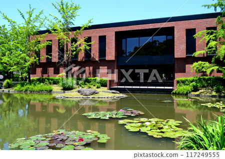 Spring garden at Ishibashi Cultural Center, Kurume City, Fukuoka Prefecture. Scenery with a pond next to the Kurume City Museum of Art. Spring garden at Ishibashi Cultural Center, Kurume City, Fukuoka Prefecture. Scenery with a pond next to the Kurume City Museum of Art. 117249555