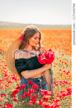 Woman poppies field. portrait happy woman with long hair in a poppy field and enjoying the beauty of nature in a warm summer day. 117249799