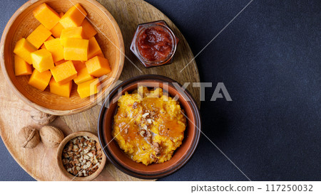 Top View of Sweet Pumpkin Porridge with ingredients and nuts 117250032