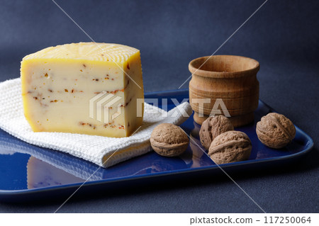 Artisan Cheese With Herbs and Nuts on a Blue Plate 117250064
