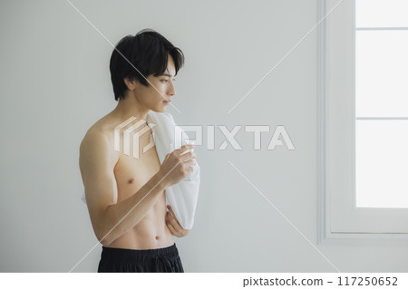 A young man drinking water 117250652