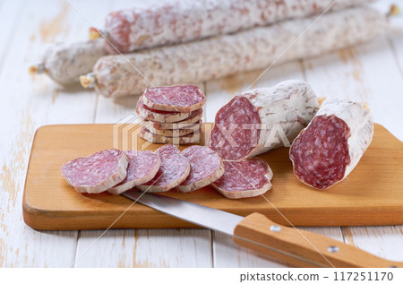 Sliced salami sausage, knife and cutting board, selective focus. Sliced salami sausage, knife and cutting board, selective focus. 117251170