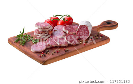 Slices of delicious spanish sausage fuet with spices and herbs on a cutting board isolated. Slices of delicious spanish sausage fuet with spices and herbs on a cutting board isolated. 117251183
