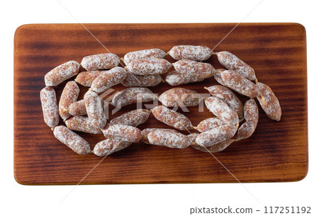 mini salami sausages on cutting board isolated on a white background, top view. mini salami sausages on cutting board isolated on a white background, top view. 117251192