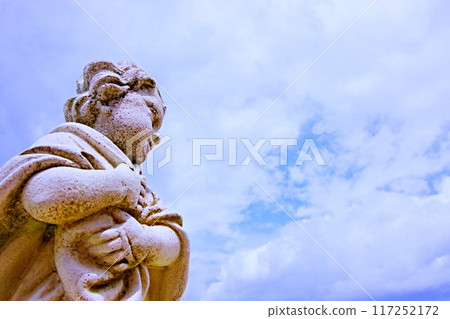 Sky and stone statues in American Village 117252172